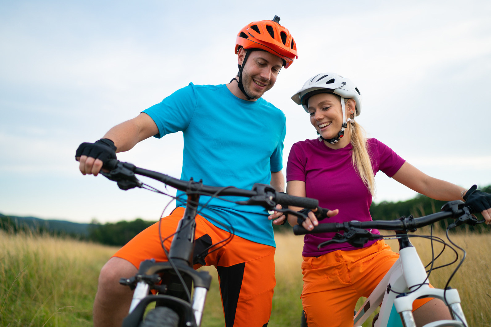 couple on e-bikes checking tachymeter